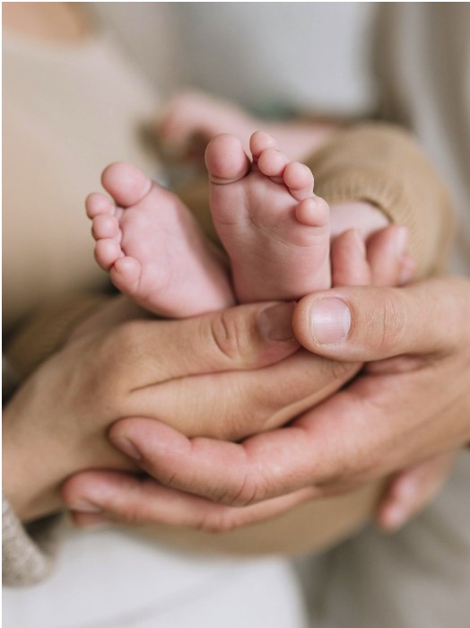 Detail photography of baby's hands and feet