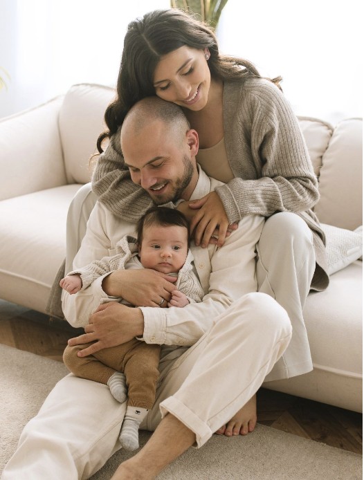 Family cuddled together on the couch