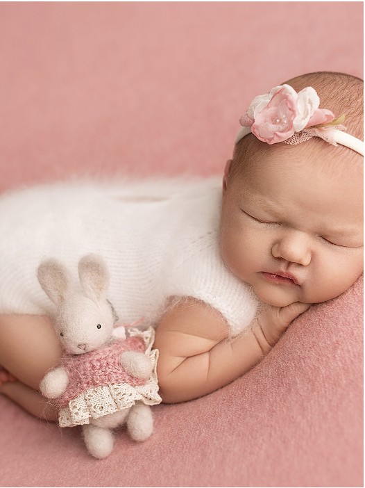 Newborn with a bunny toy