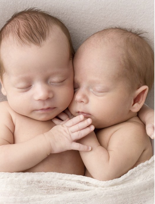 Newborn twins sleeping together